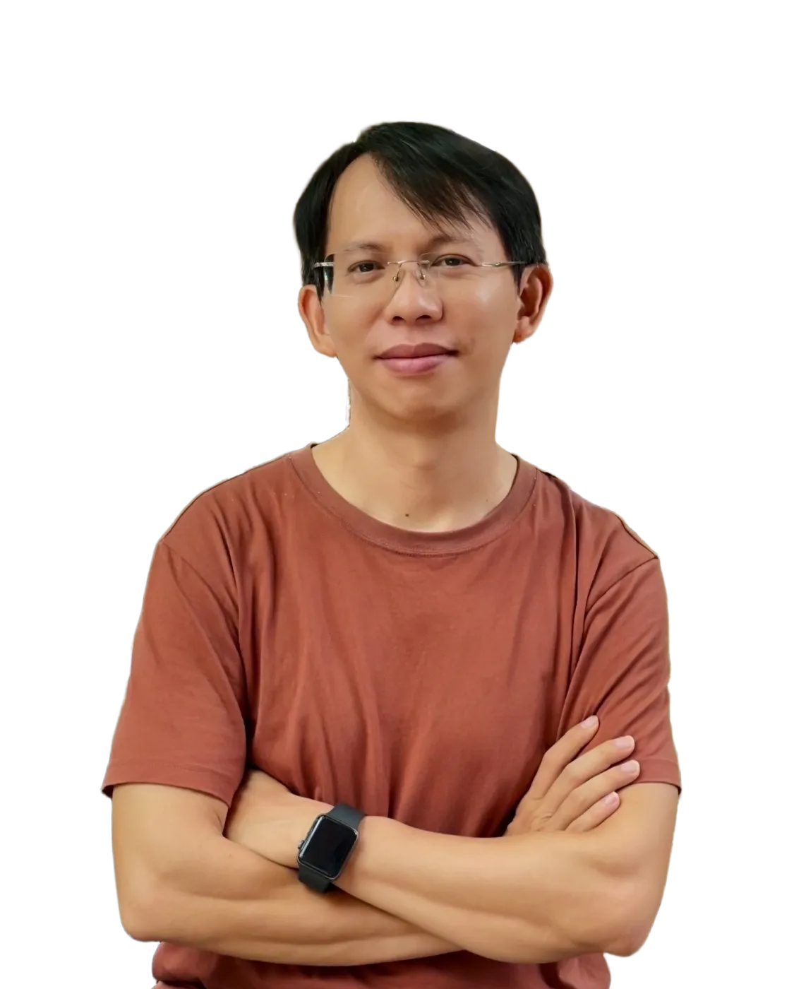 Smiling man wearing a light blue denim shirt with arms crossed